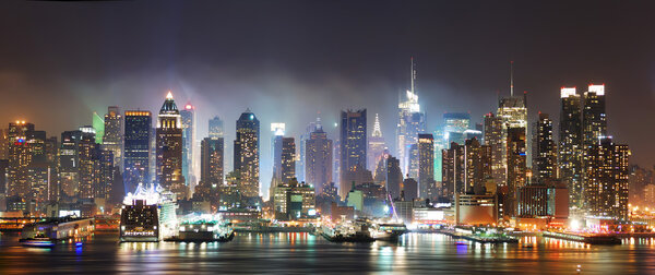 New York City Manhattan skyline panorama at night over Hudson River with refelctions viewed from New Jersey