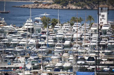 Yachts in marina on sunny day clipart