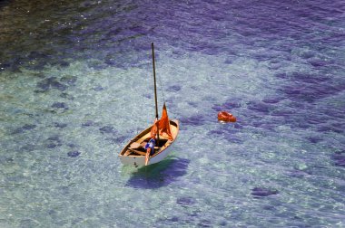 Orange boat on the sea clipart