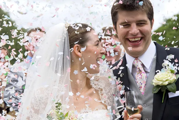 Braut und Bräutigam in Konfettidusche Stockfoto