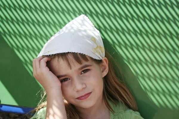 Sad little girl with green background — Stock Photo, Image