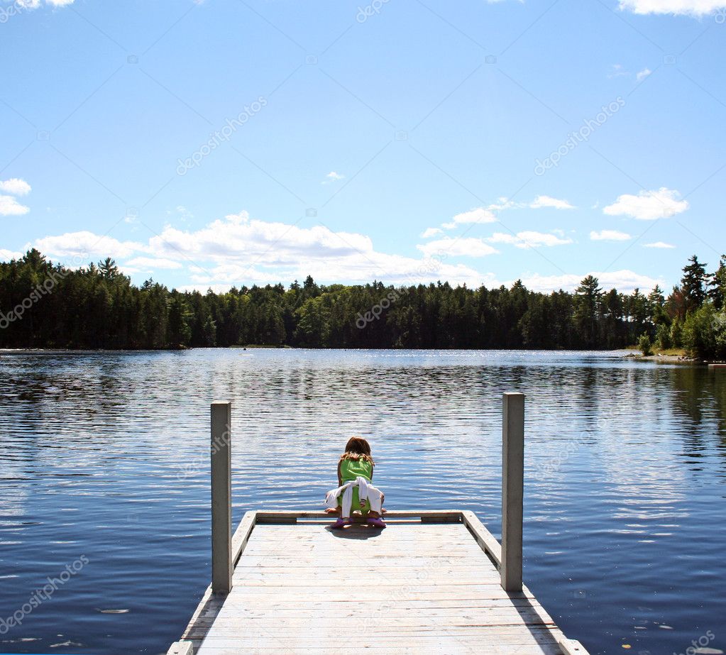 Child on dock at lake