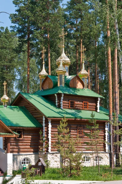 stock image Wooden orthodox church among the trees