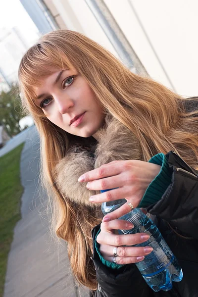 Young blond girl with a bottle of water — Stock Photo, Image