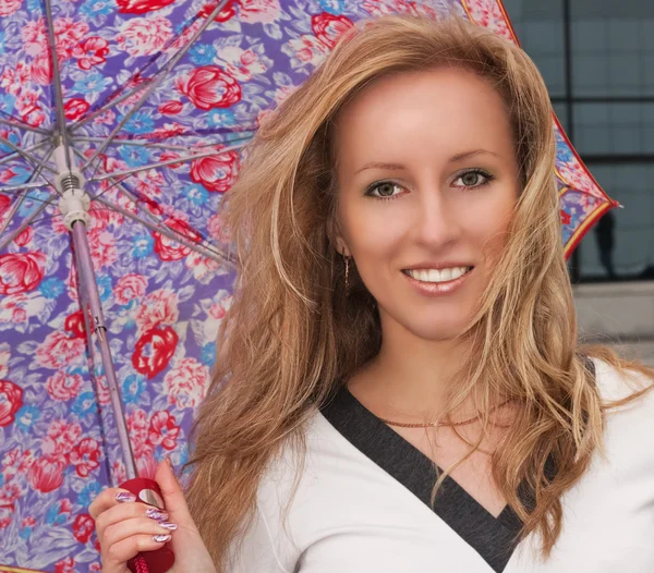 Lovely young blond girl with an umbrella — Stock Photo, Image