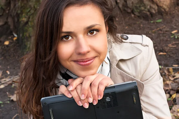 Cute young girl with a laptop — Stock Photo, Image