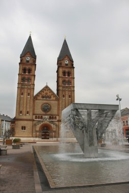 Roman catholic church and fountain on an area before him. clipart