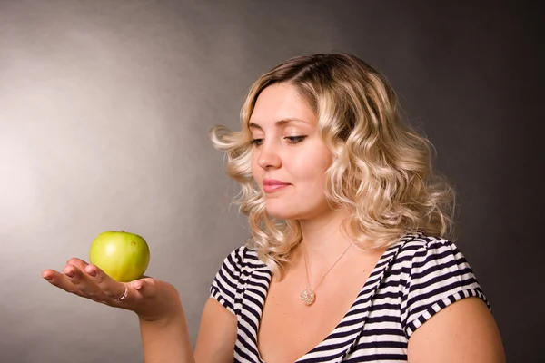 stock image Portrait of beautiful young woman of blonde with a green apple