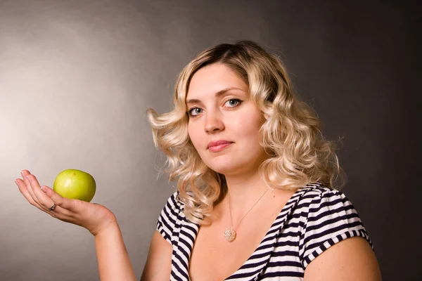 stock image Portrait of beautiful young woman of blonde with a green apple