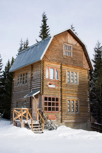 Three-storeyed wooden house concealed by snow, Ukraine, Carpathi — Stock Photo, Image