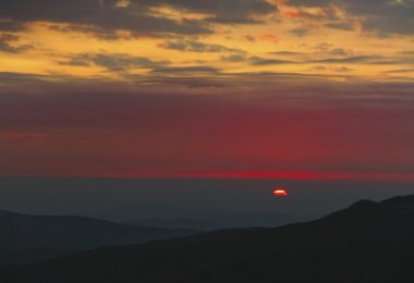 Red sunset in high mountains clipart