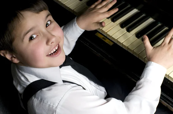 stock image Little boy and piano.