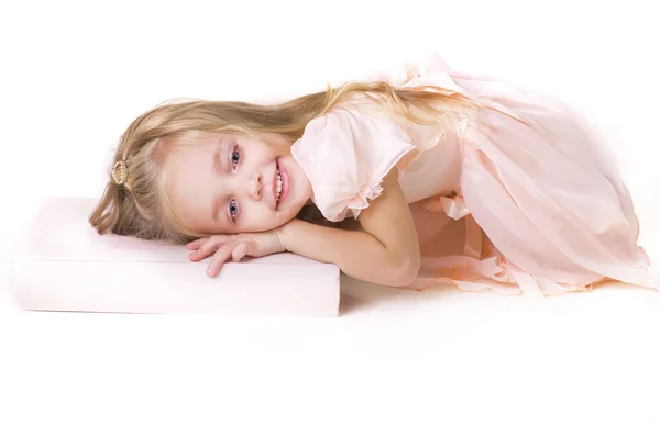 A ittle girl lies on book — Stock Photo, Image