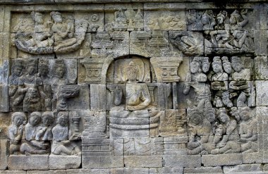 Stone carving in the Borobudur temple near Yogyakarta on Java is clipart