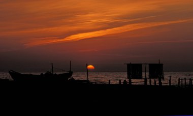 FISHING BOAT AT SUNSET clipart