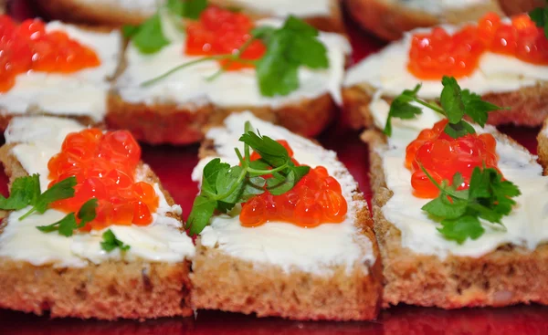 stock image Sandwich with red caviar and greens