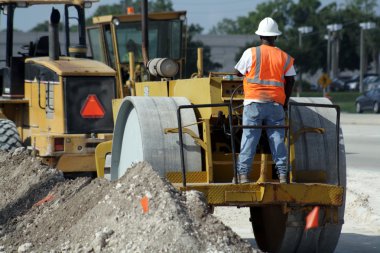 Worker Operating a Compactor (1) clipart