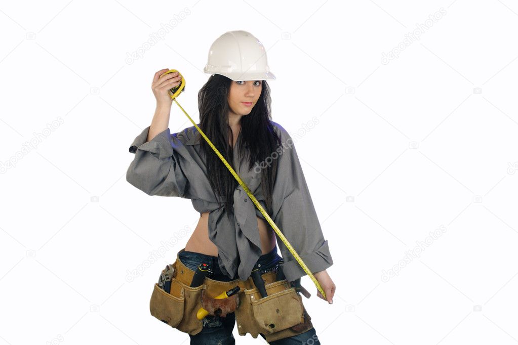 A lovely young teenage girl wearing a white hardhat and a well-worn toolbelt.