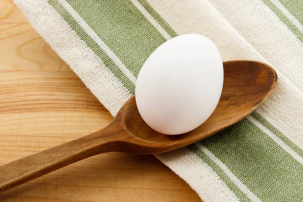Ganzes weißes Ei im Holzlöffel — Stockfoto