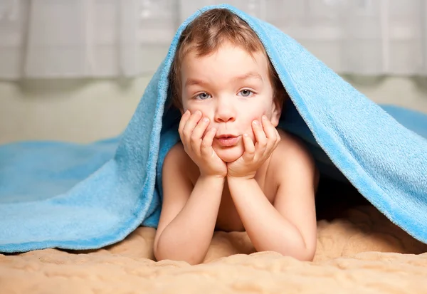 Little boy under a blue blanket — Stock Photo, Image
