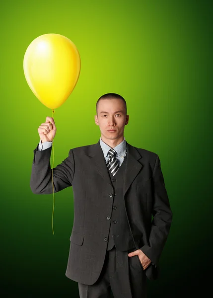Uomo d'affari in giacca e cravatta con palloncino — Foto Stock