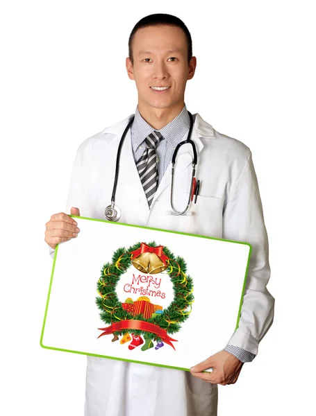 Doctor with empty board with Merry Christmas picture — Stock Photo, Image