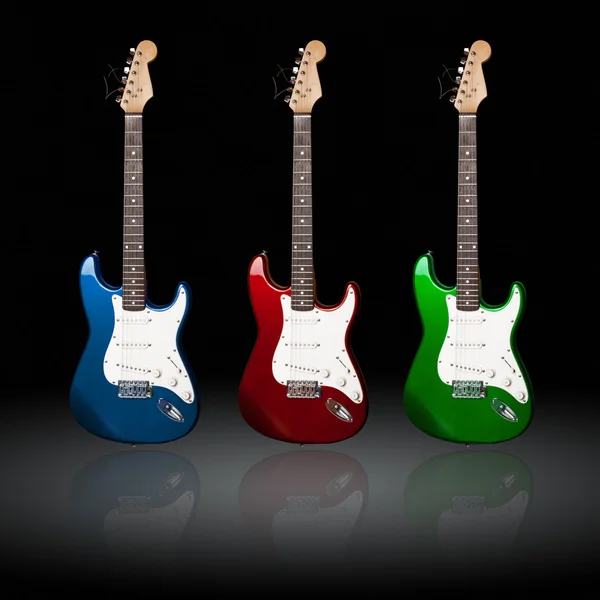 stock image Three electric guitars of different colors with reflections