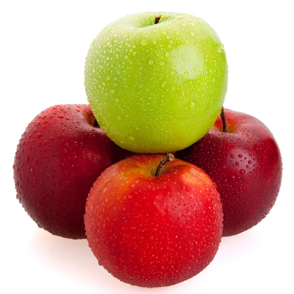 3 rote und 1 grüne Äpfel Stockbild