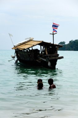 The children of local fishermen are playing the water fun. clipart