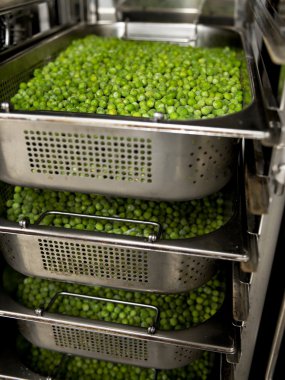 Frozen peas in the steamer clipart