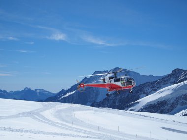 Helicopter take-off at Jungfraujoch Top of Europe in the Swiss M clipart