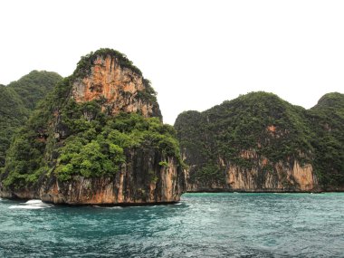 The Phi Phi Islands are located in Thailand , between the large island of Phuket and the western Andaman Sea coast of the mainland. The islands are administrati clipart