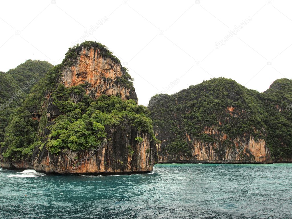 The Phi Phi Islands are located in Thailand , between the large island of Phuket and the western Andaman Sea coast of the mainland. The islands are administrati