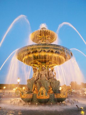 Fountain at the Place de la Concorde at night Paris clipart