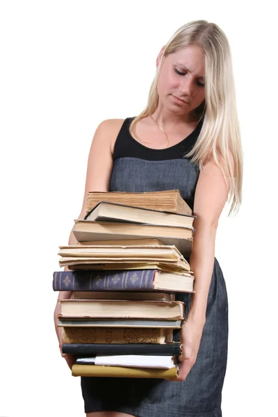 Женщина с тяжёлой стопкой книг — стоковое фото
