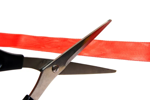 Scissors cutting a red ribbon. — Stock Photo, Image