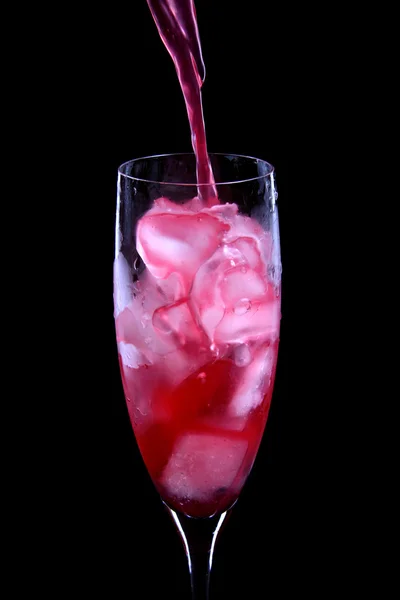 Red cocktail being poured into a glass — Stock Photo, Image