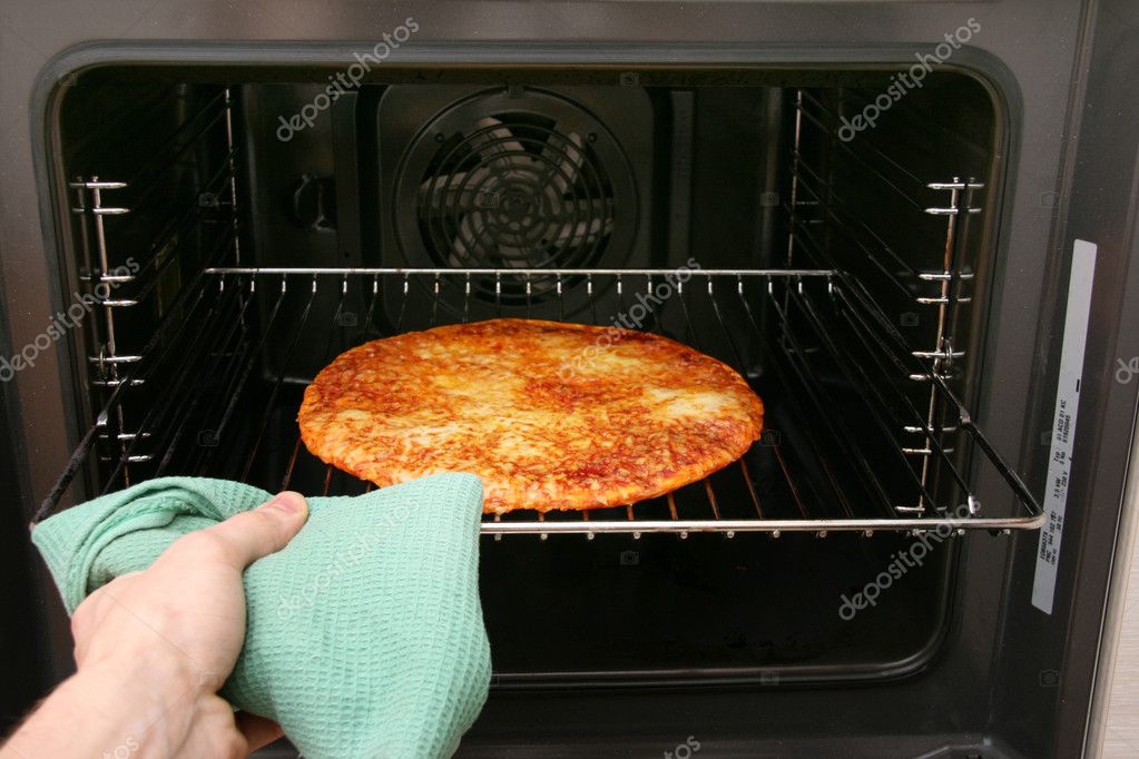 Hand take pizza out of oven — Stock Photo © ronstik 4302980