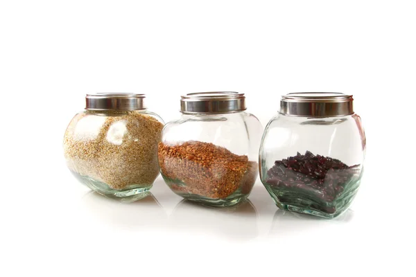 Grains and cereals in the glassy jars — Stock Photo, Image