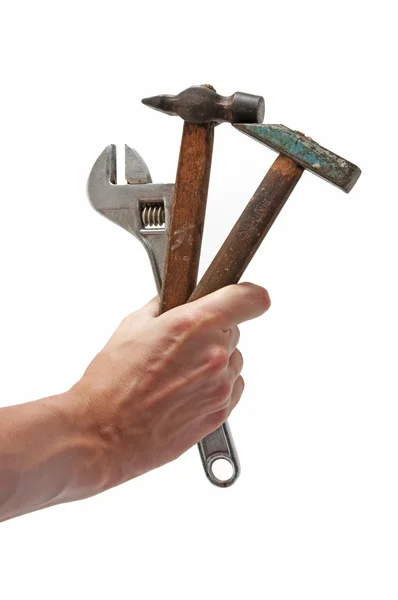 Skiftnyckel och 2 hammare i handen — Stockfoto