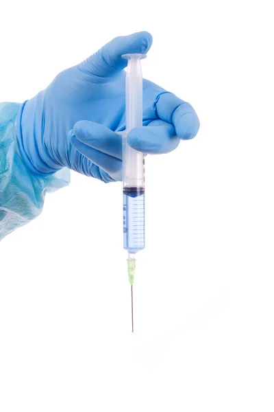 Hand with a medical syringe, isolated on white — Stock Photo, Image