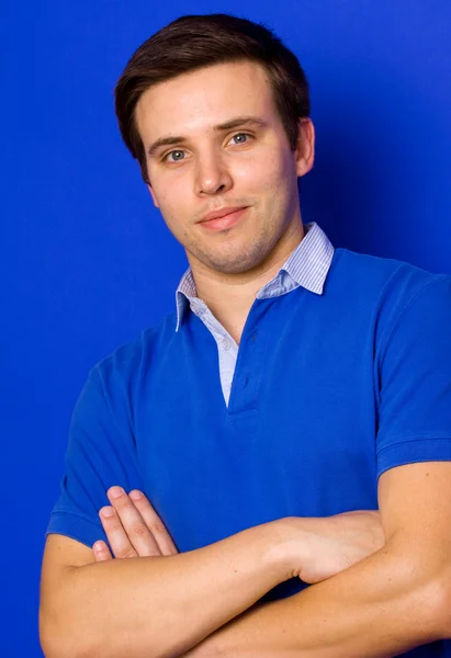 Retrato de jovem homem casual, em um fundo azul — Fotografia de Stock