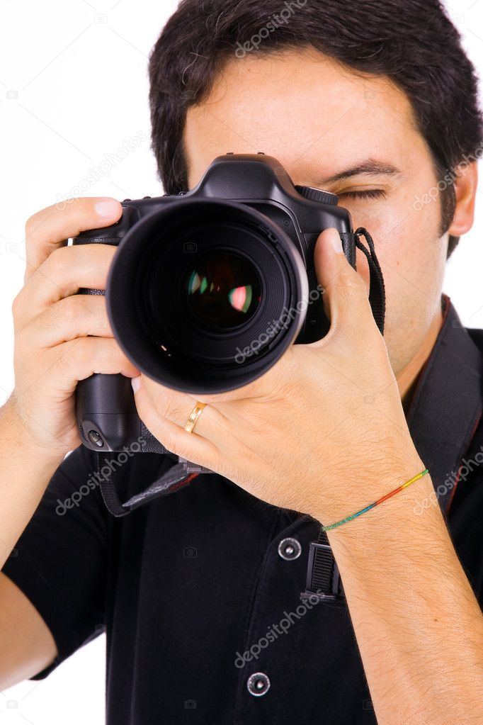 Close up portrait of a young photographer with camera at the stu