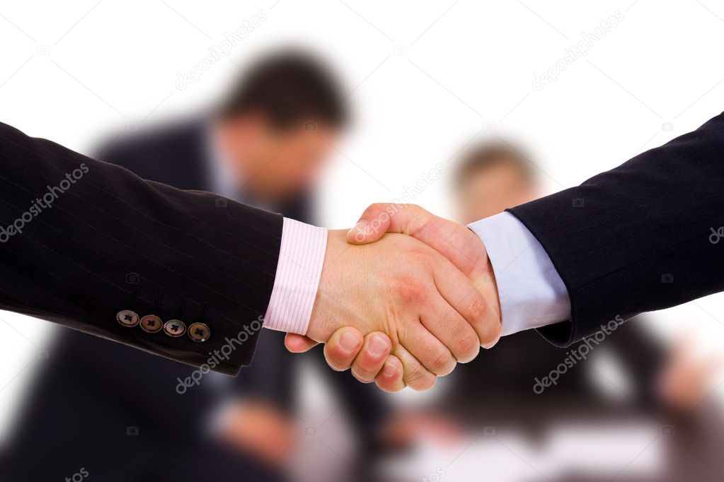 Closeup of business shaking hands at the office