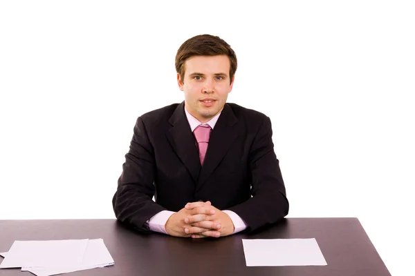 Jonge zakenman op een bureau, geïsoleerd op wit — Stockfoto