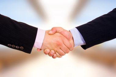 Closeup of business shaking hands at the office