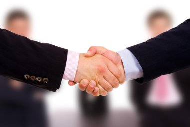 Closeup of business shaking hands at the office clipart