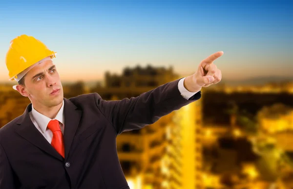 stock image Young architect wearing a protective helmet standing in front of