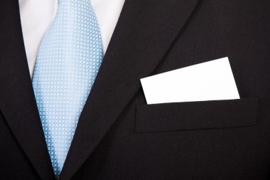 Businessman with a blank business card in his pocket clipart