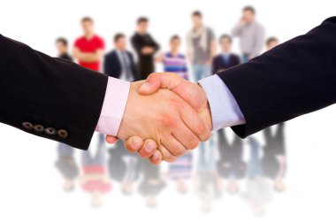 Business man hand shake with colleagues in the background. clipart